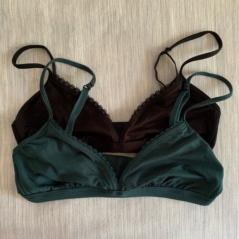 Two Reformation Kass bralettes in black and pine